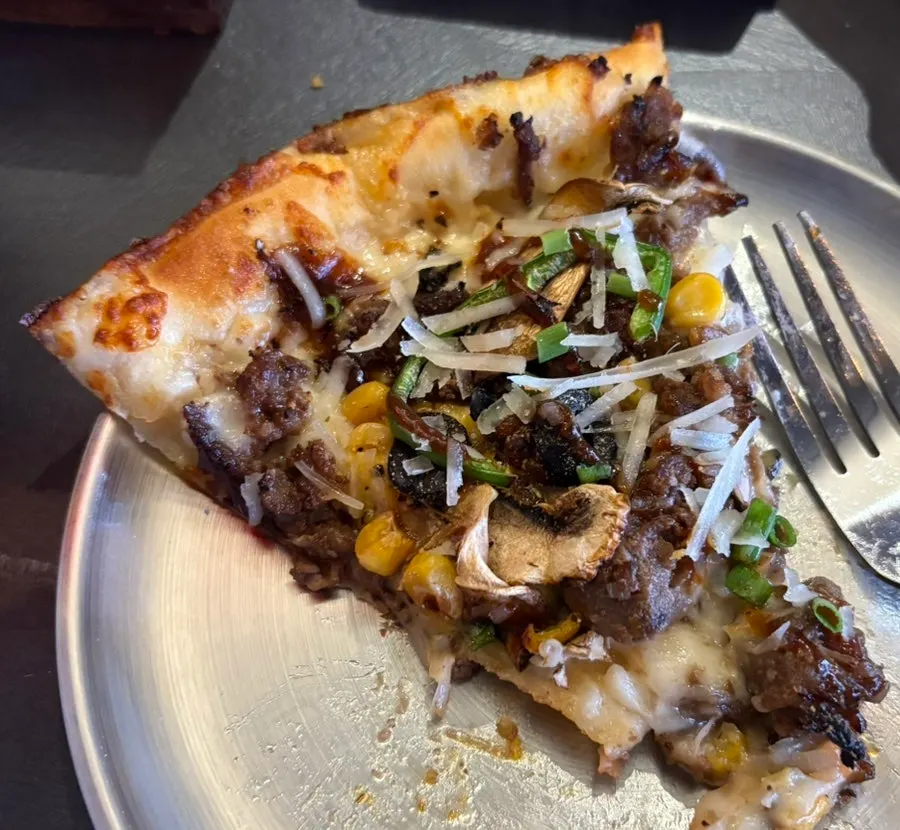 Horizontal shot of the full half-and-half pizza spread