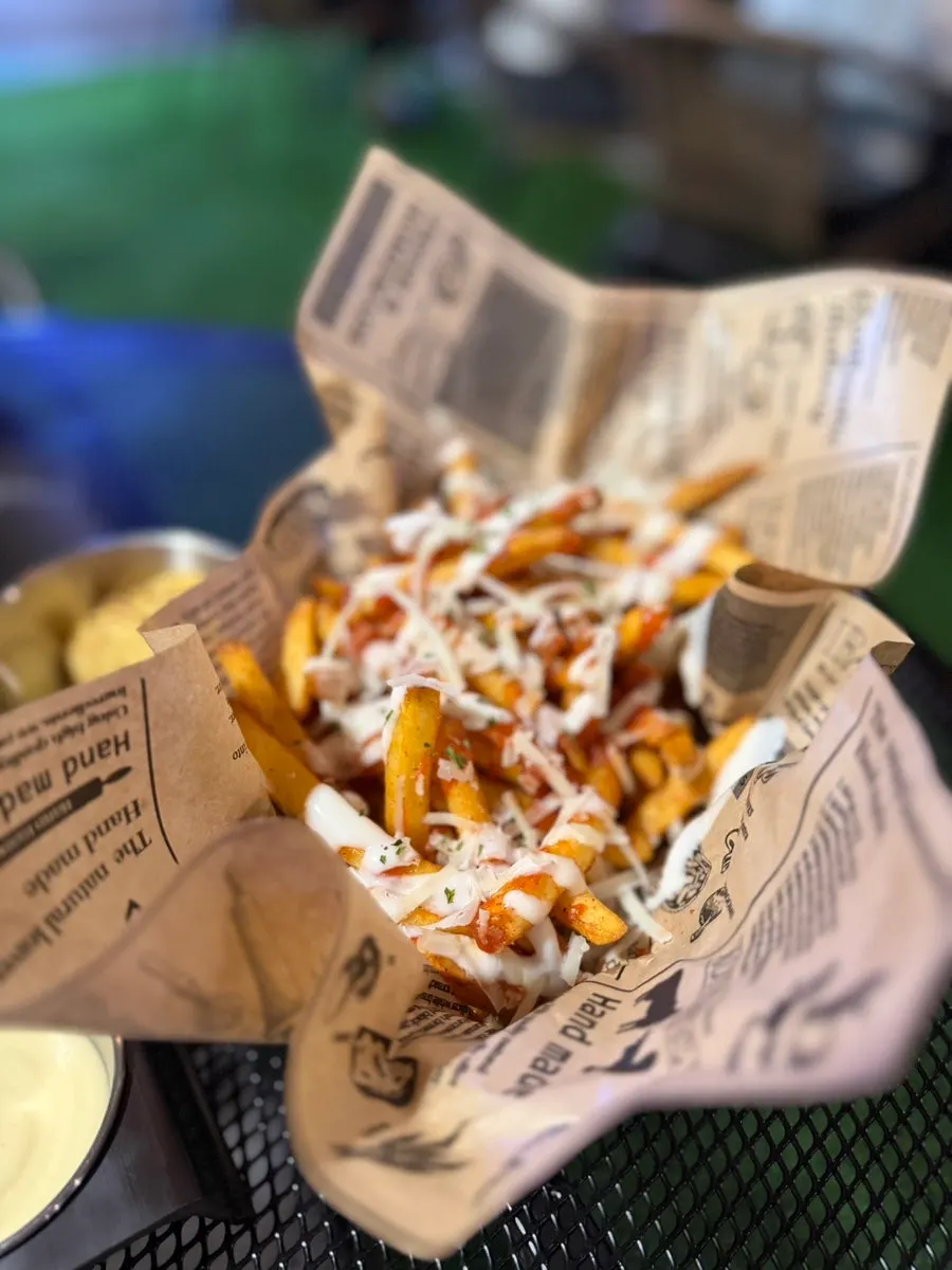 Close-up of fries topped with chili and cheese sauce