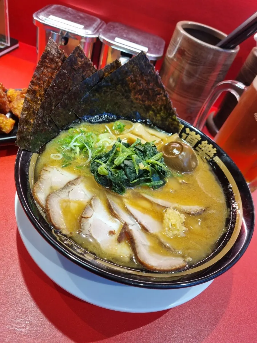 Ramen topped with chashu, nori, spinach, and soft-boiled egg