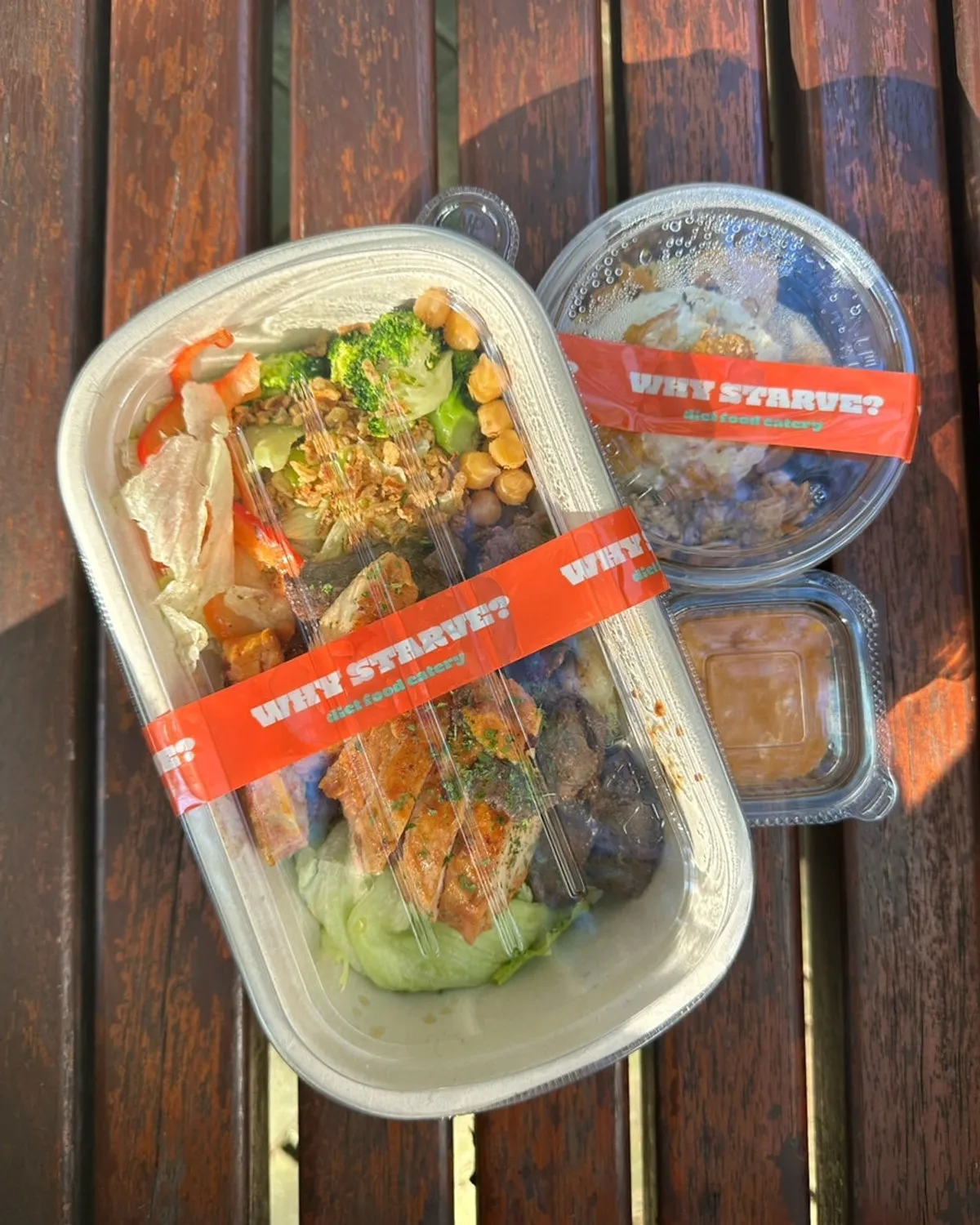 Takeout protein box containers laid out in the park