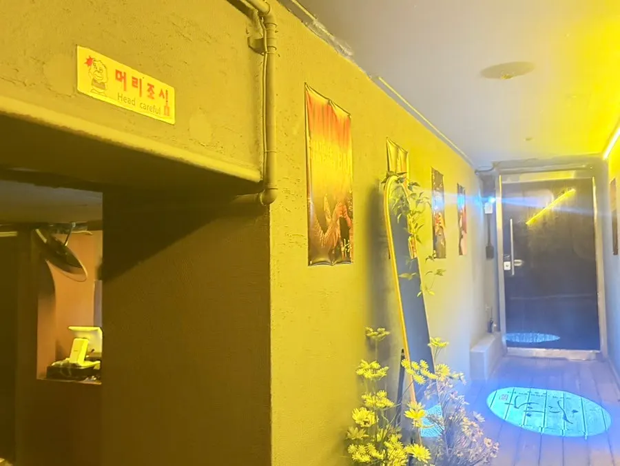 Bar hallway with posters and a full-length mirror