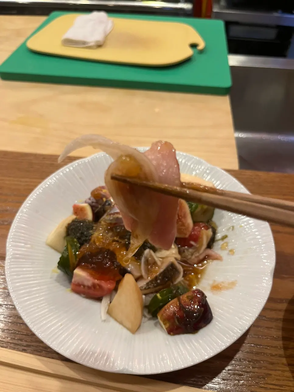 Close-up of seafood ceviche topped with figs and pear