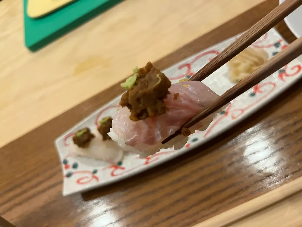 Flounder sushi topped with monkfish liver and wasabi