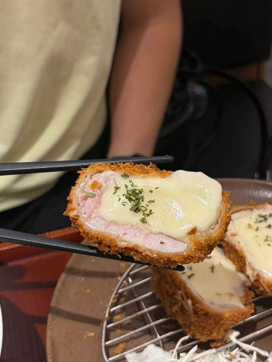 Cross-section of tonkatsu showing meat and cheese
