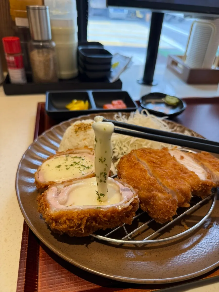 Cross-section of cheese tonkatsu stretching with cheese