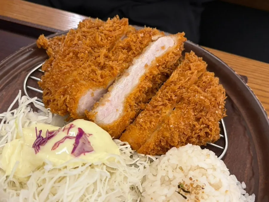 Two full spreads of udon and tonkatsu set on the table at Kosi Isu Branch