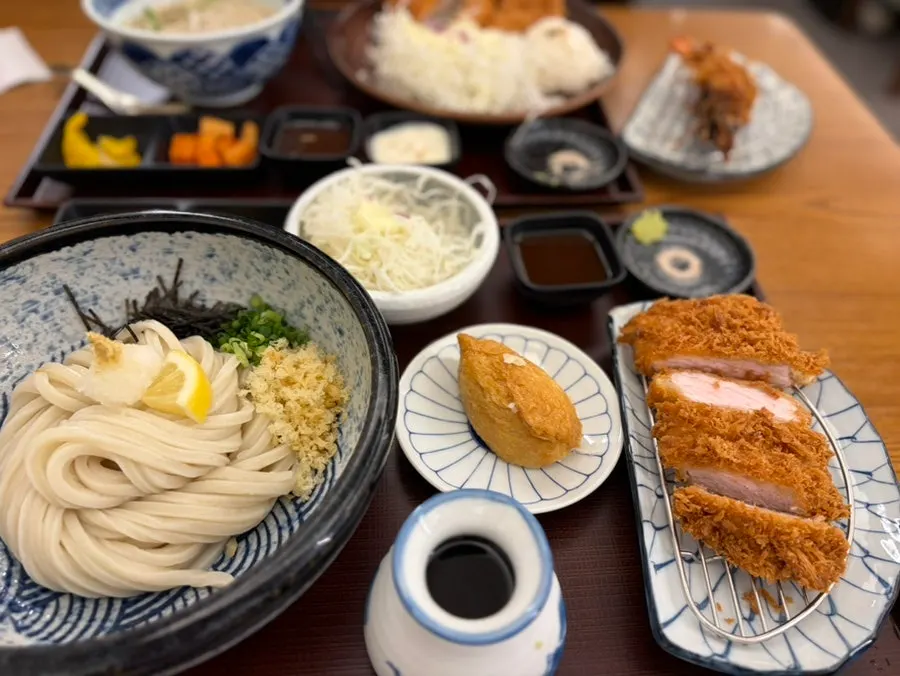 Table spread with bukkake udon, inari sushi, and added tonkatsu