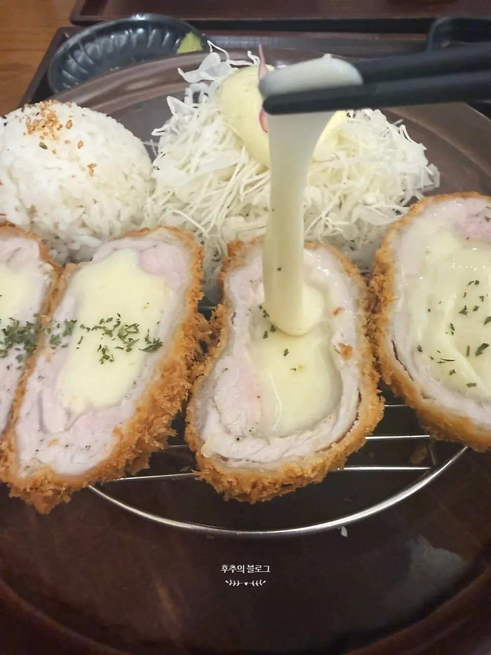 Cross-section of cheese katsu with stretchy cheese pull