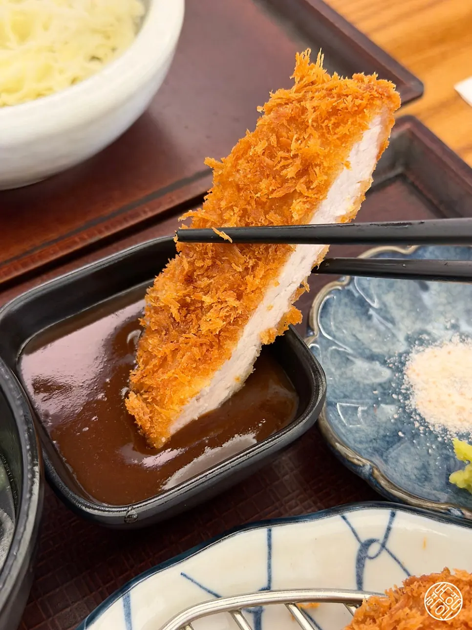 Cross-section of katsu batter dipped in sauce