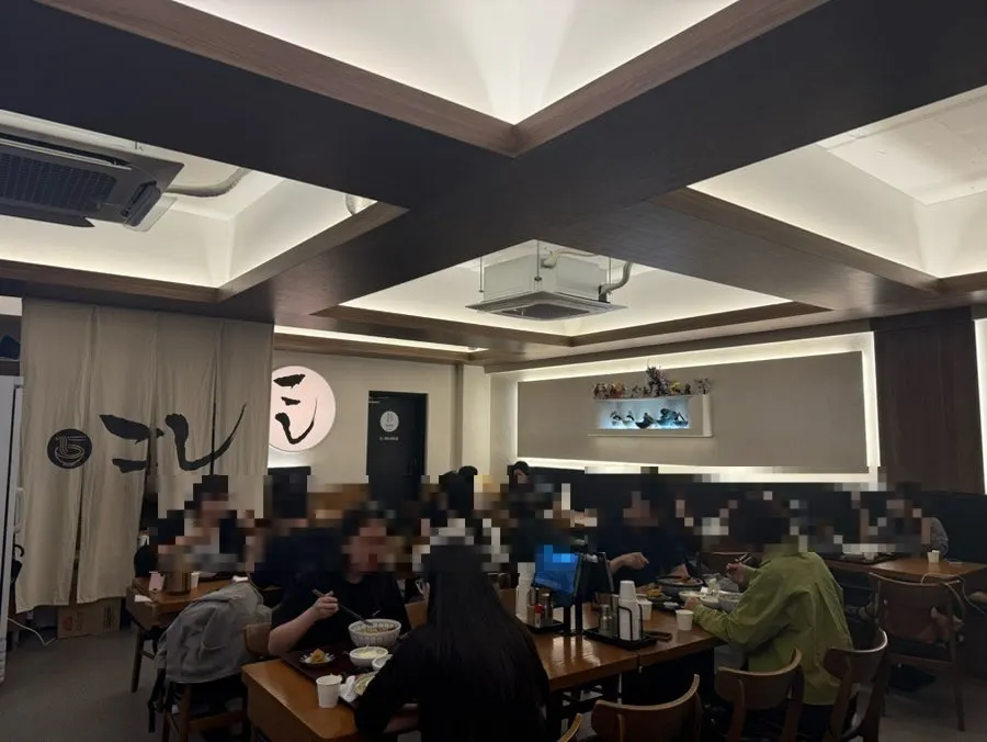 Interior of Kosi Konkuk University Branch with wide tables