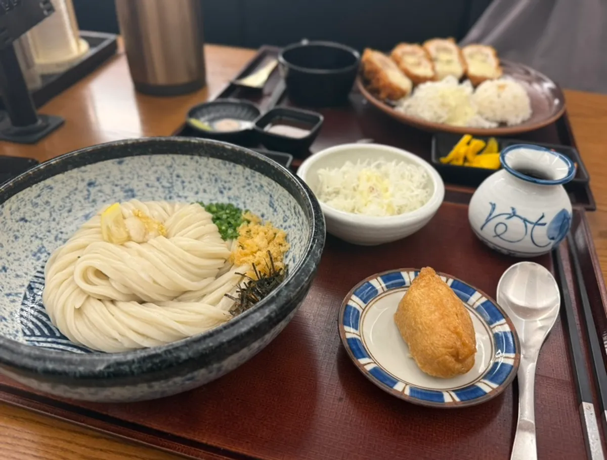 Self-made noodle bukkake udon and handmade cheese katsu spread on the table
