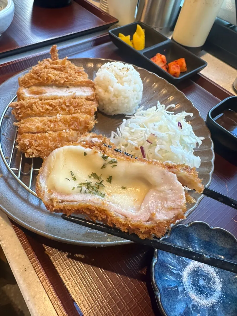Cross-section of cheese katsu with cheese oozing out
