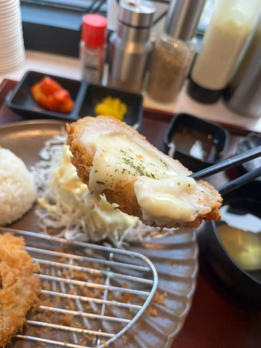 Alternating bites of loin katsu and cheese katsu from the half-and-half set