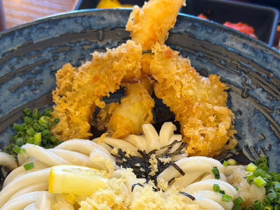 Shrimp tempura and pumpkin tempura on top of udon