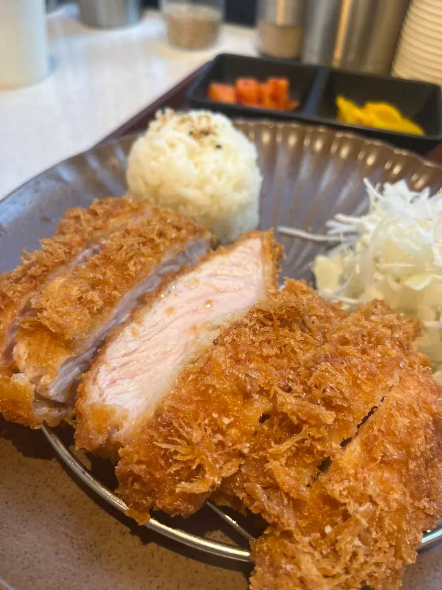 A piece of pork loin tonkatsu lifted up