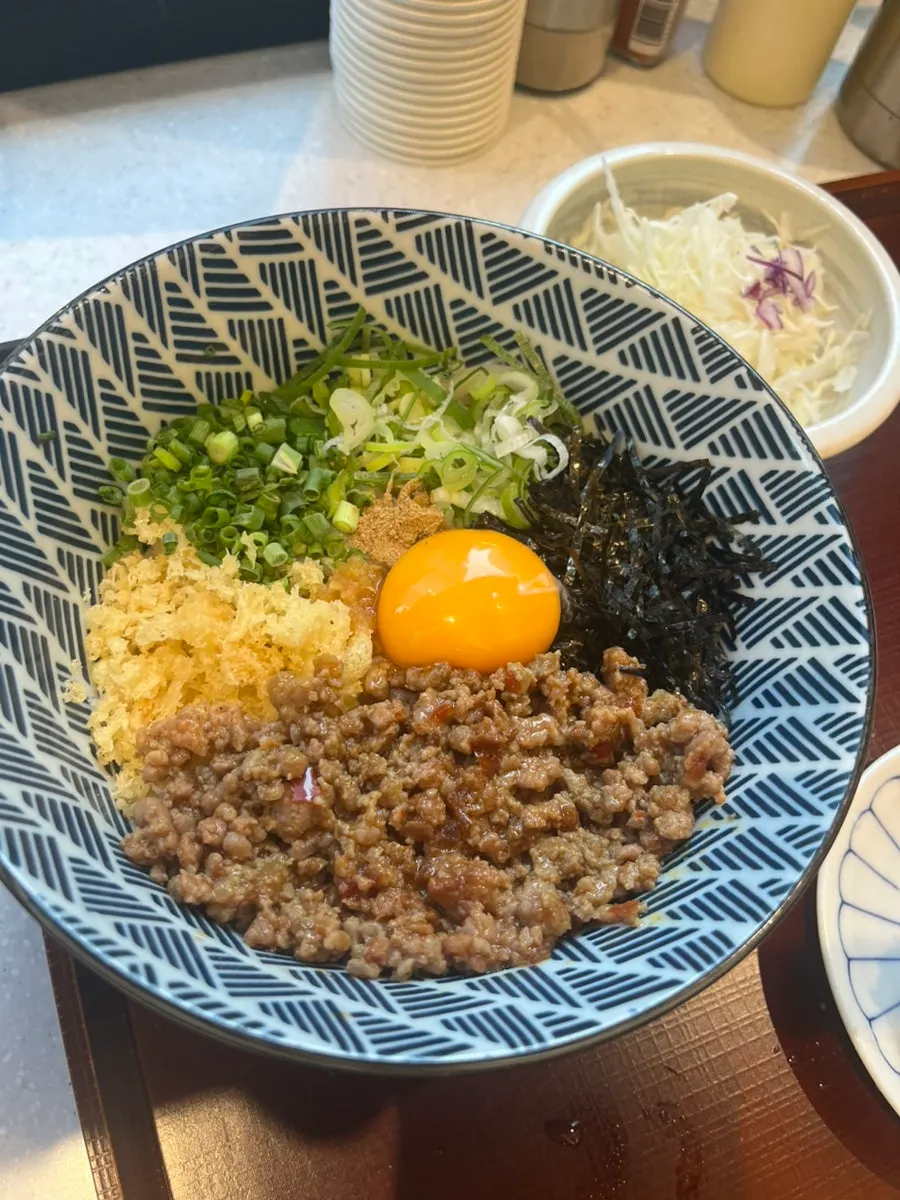Mazesoba udon topped with meat and sauce
