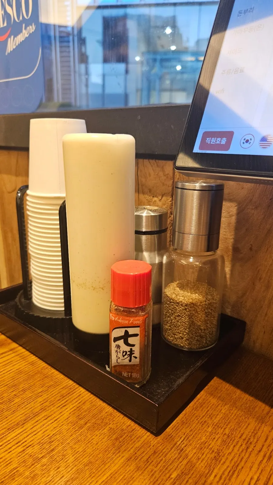 Sesame grinder and salad dressing on the table