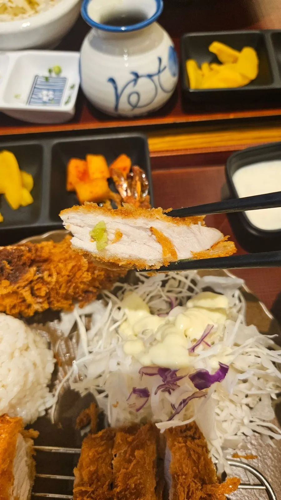Loin cutlet piece held with chopsticks