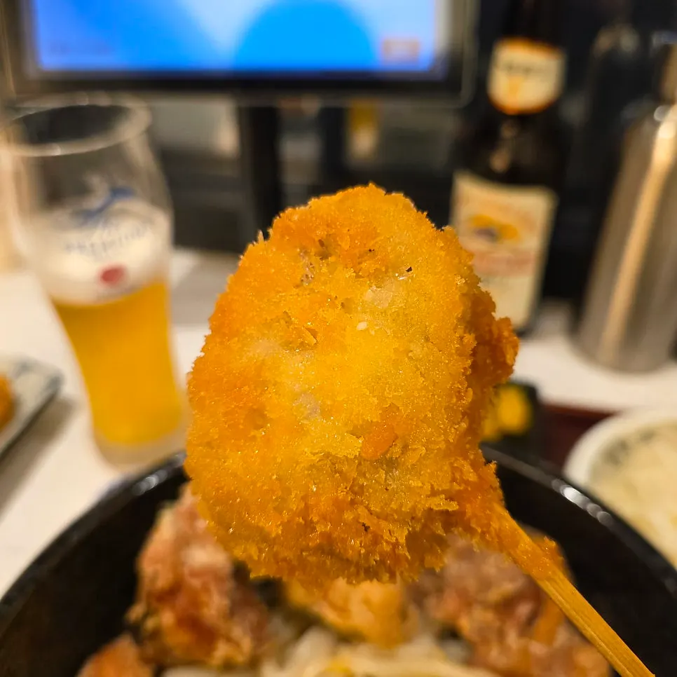 Two pieces of freshly-fried lotus root kushikatsu
