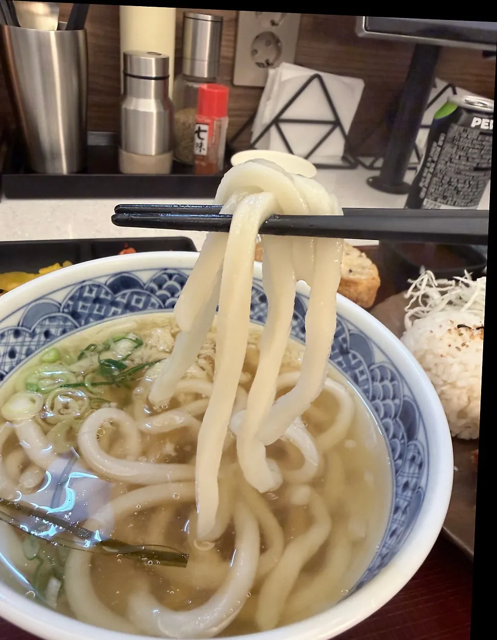 Plump udon noodles lifted with chopsticks