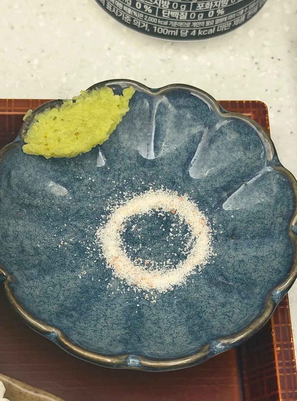 Table setting with pepper and shichimi seasoning