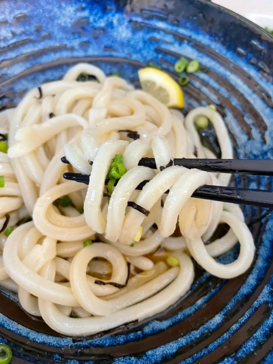 Bukkake udon topped with tsuyu, scallions, and grated radish