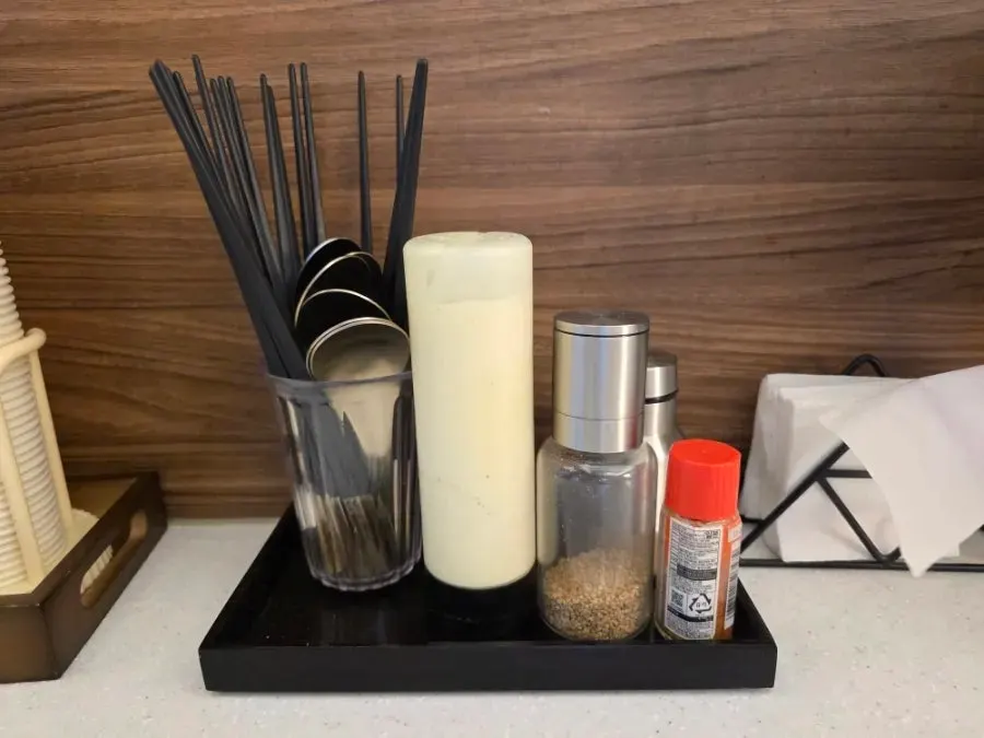 Salad dressing and cutlery set out on the table