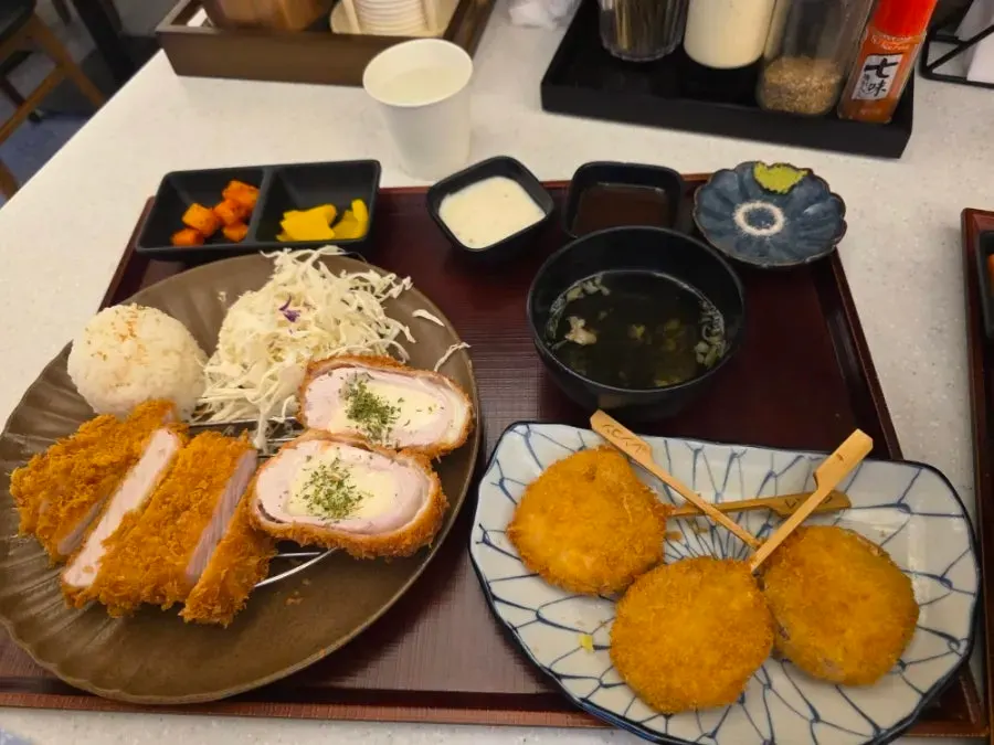 Table set with half-and-half katsu, udon, and sides