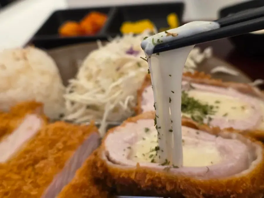 Cross-section of the cheese katsu with cheese stretching out