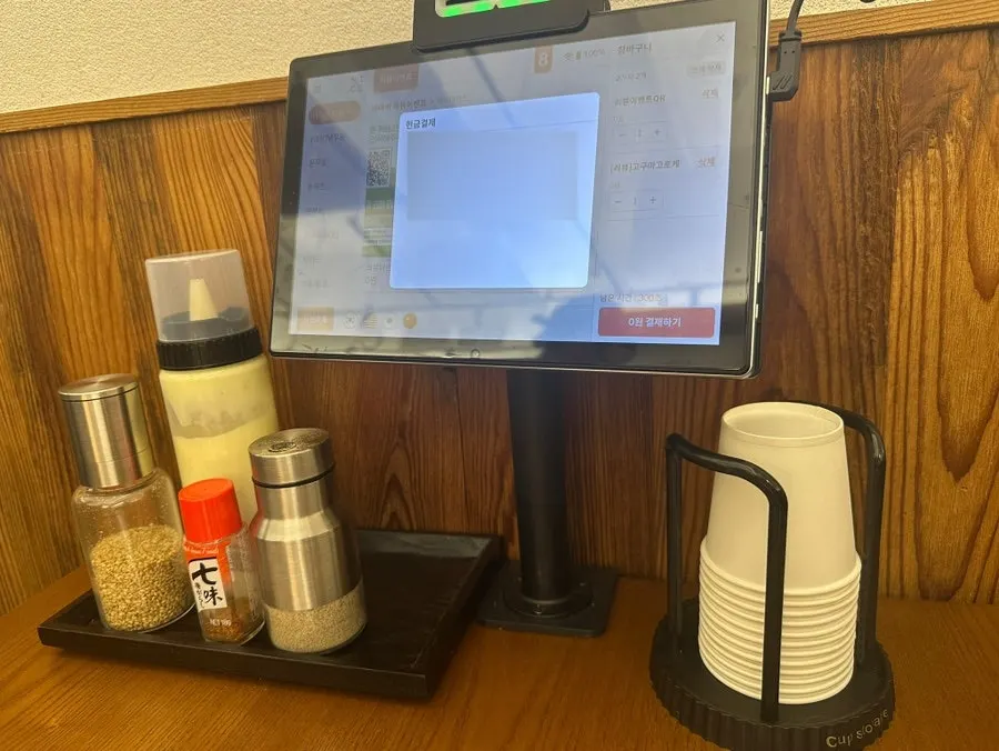 Table setting with an ordering kiosk at Kosi Seoul National University Entrance Branch