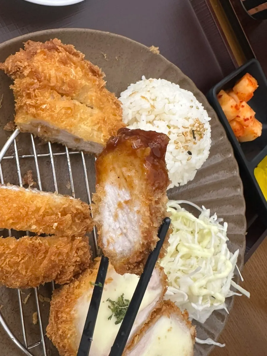 Dipping the pork cutlet in sauce