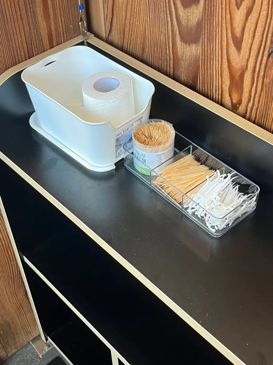 Tissues and toothpicks organized near the door