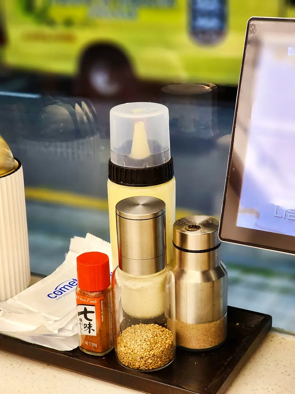 Sauces and an ordering tablet on the bar table