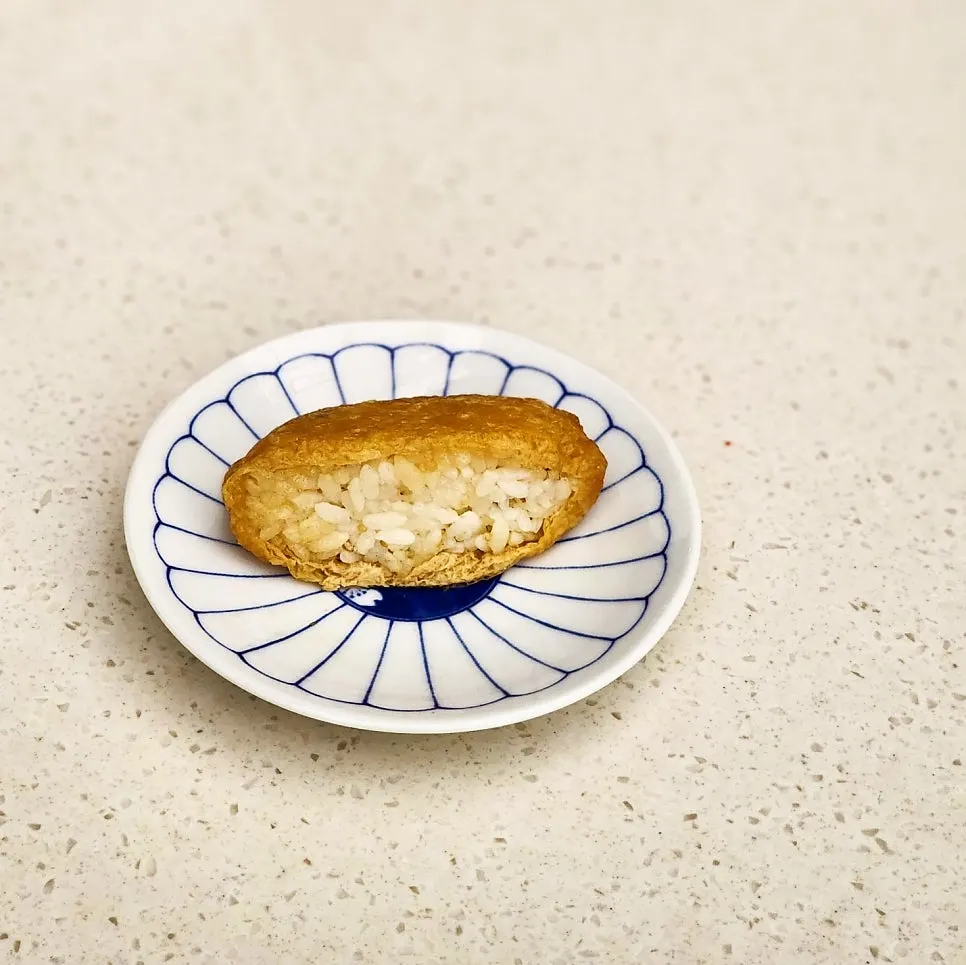 Inari sushi served alongside the udon