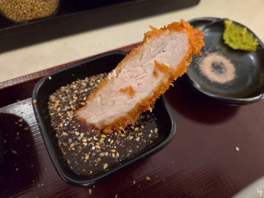Tonkatsu dipped in sauce with ground sesame