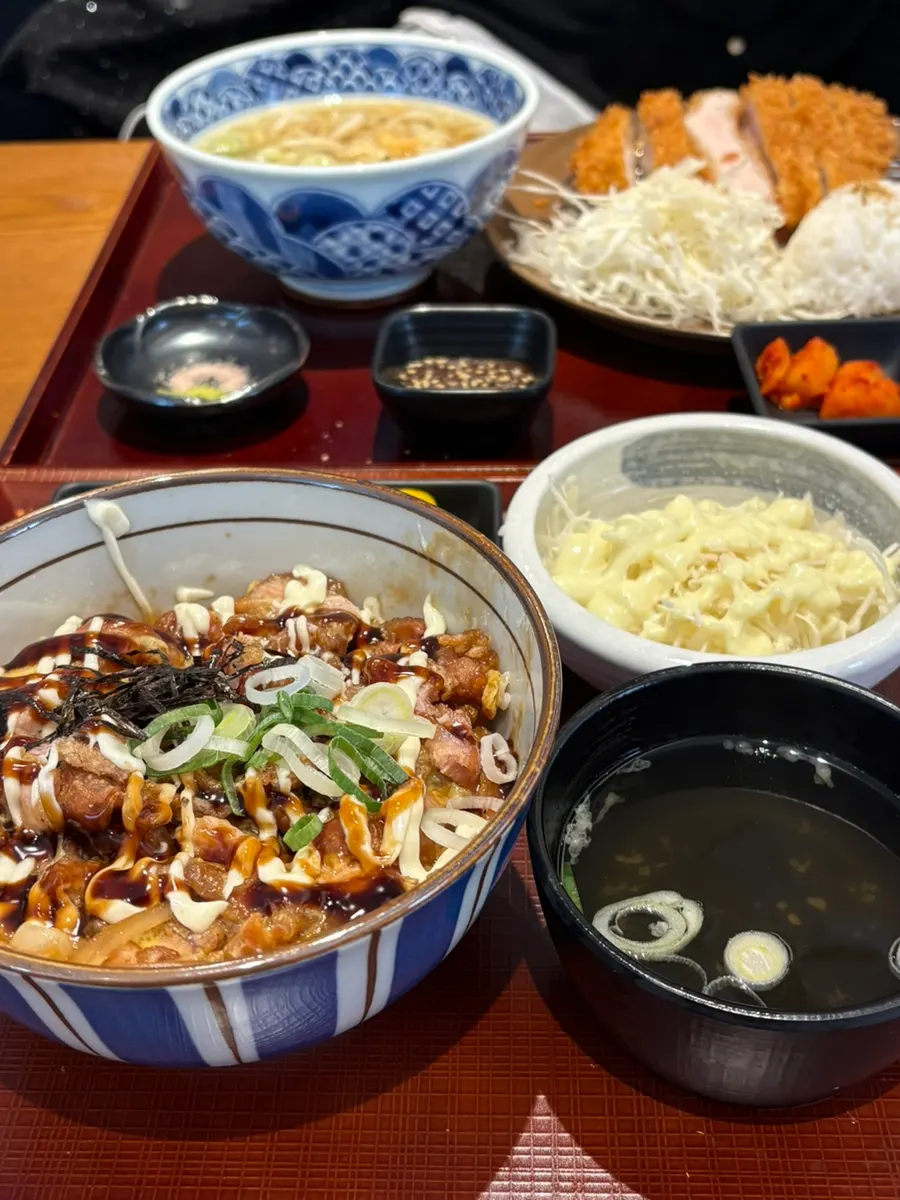 Table set with fresh pork loin tonkatsu udon set and karaage don