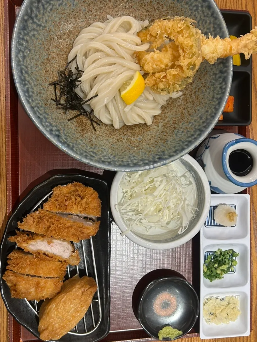 Table setup with tenbukkake udon set and fish cake udon set