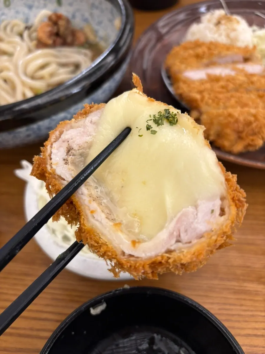 A piece of cheese katsu with stretchy cheese