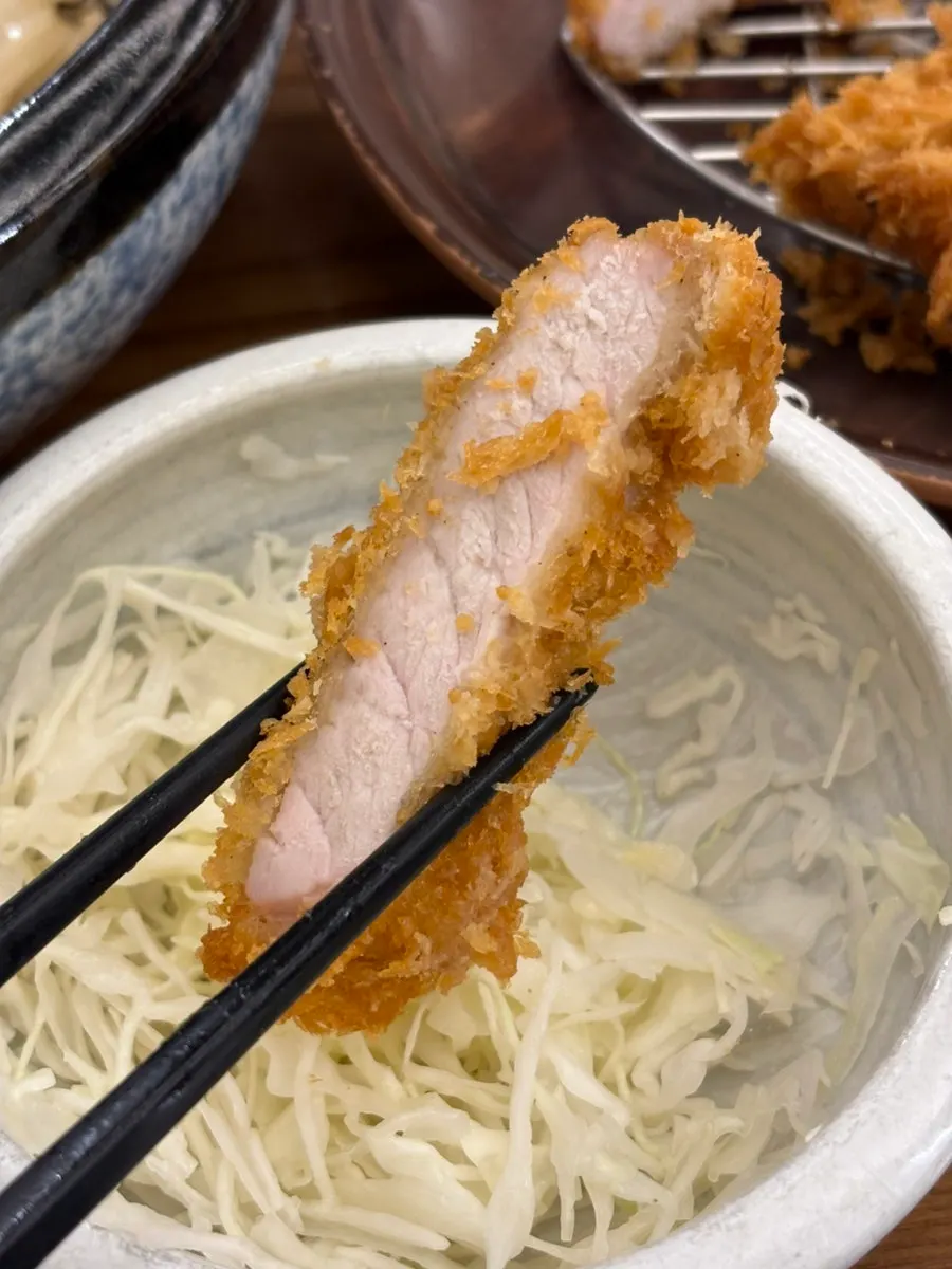 A bite of crispy-breaded pork loin katsu