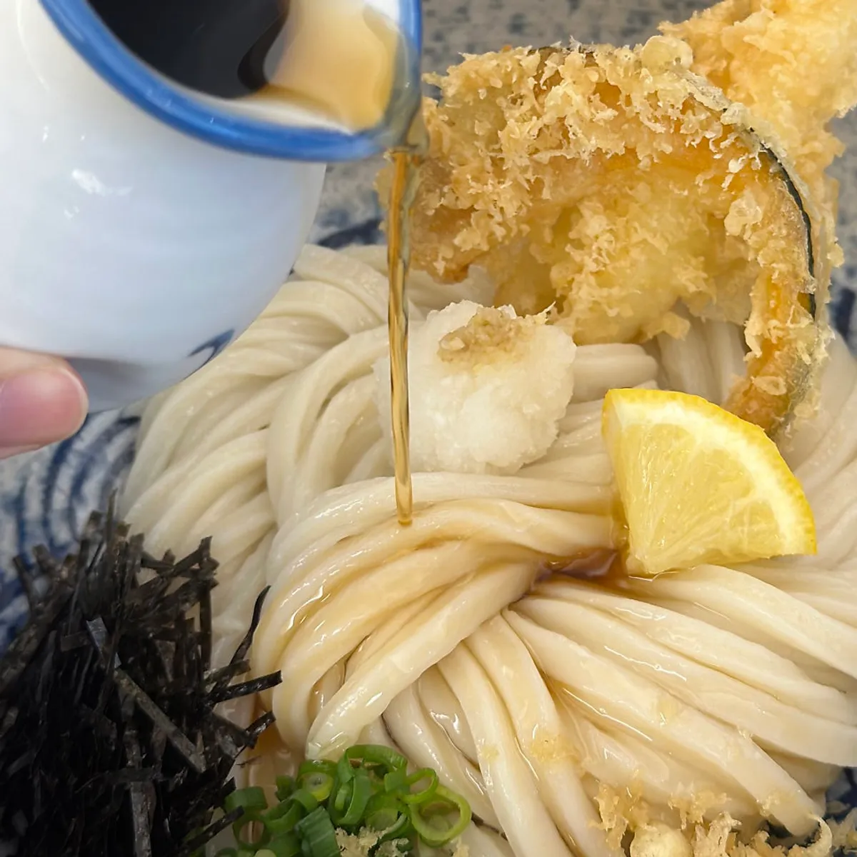 Tenbukkake udon topped with fried shrimp and pumpkin