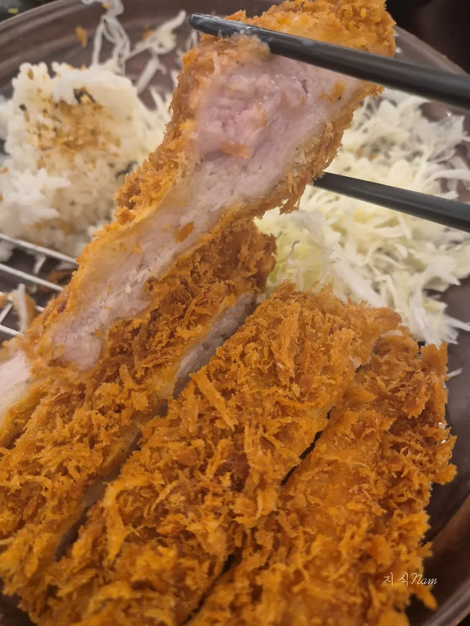 Sesame seeds and tonkatsu sauce set out on the table