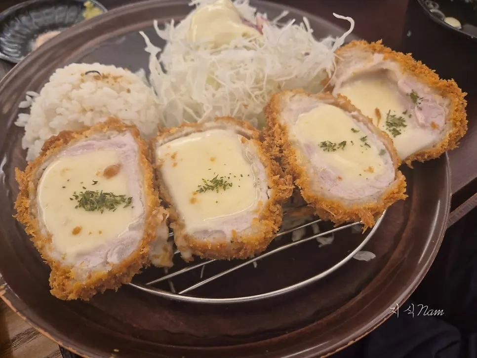 A crispy piece of tonkatsu dipped in sauce