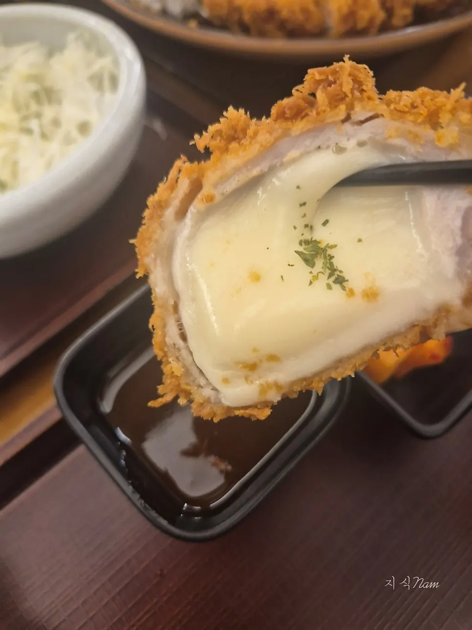 Cross-section of cheese tonkatsu packed with melted cheese