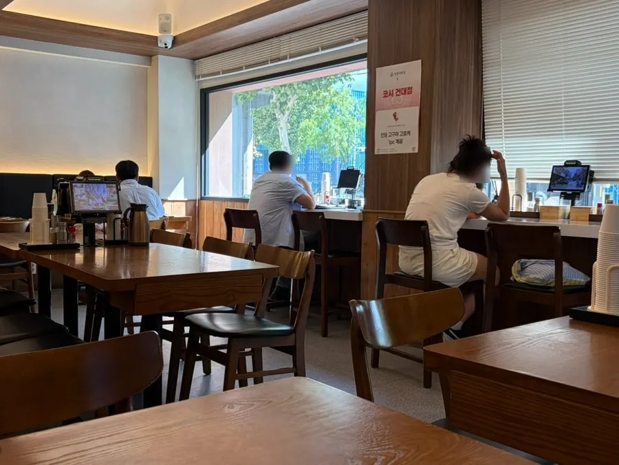 Wood-toned interior of Kosi Konkuk University Branch