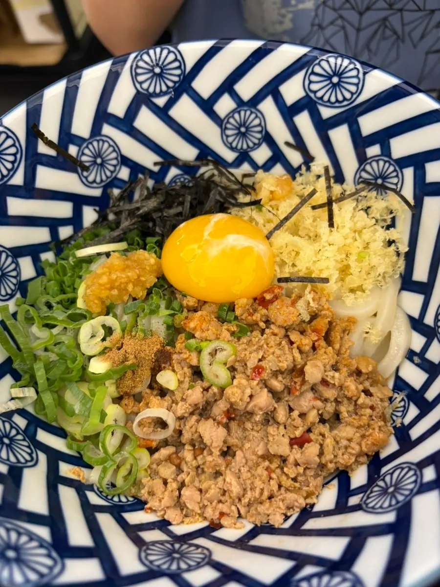 Full spread of ten bukkake udon with inari sushi and salad