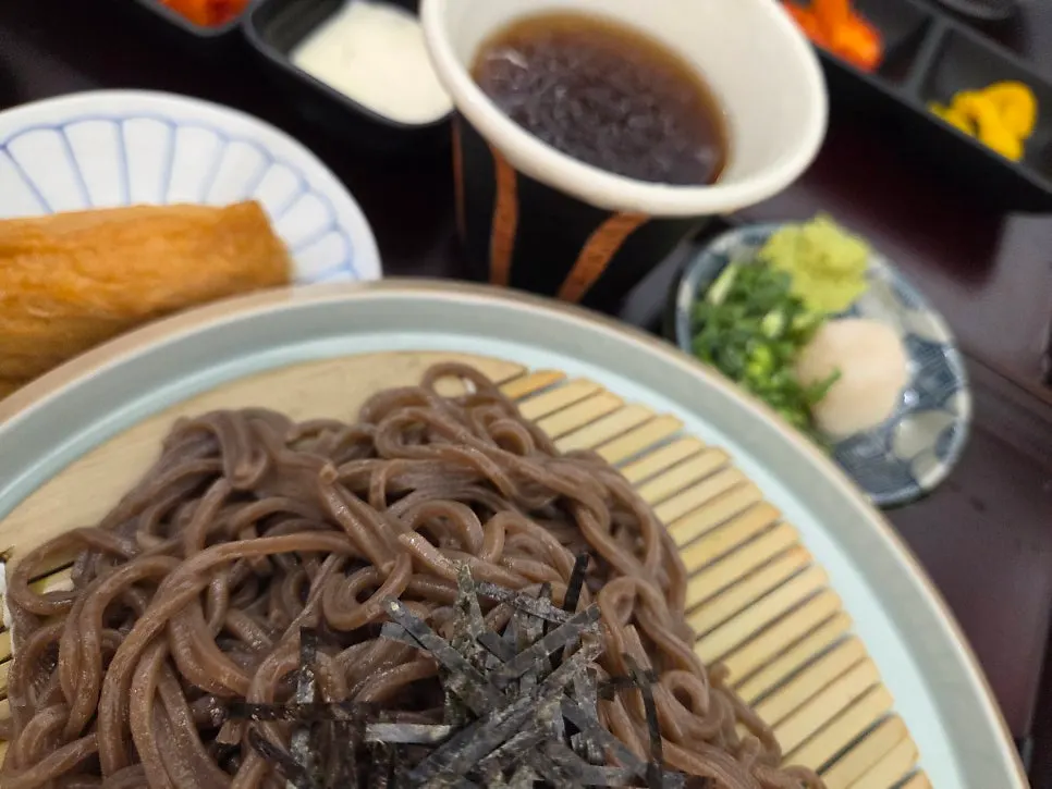 Kosi's soba noodles on a wide plate with tsuyu sauce