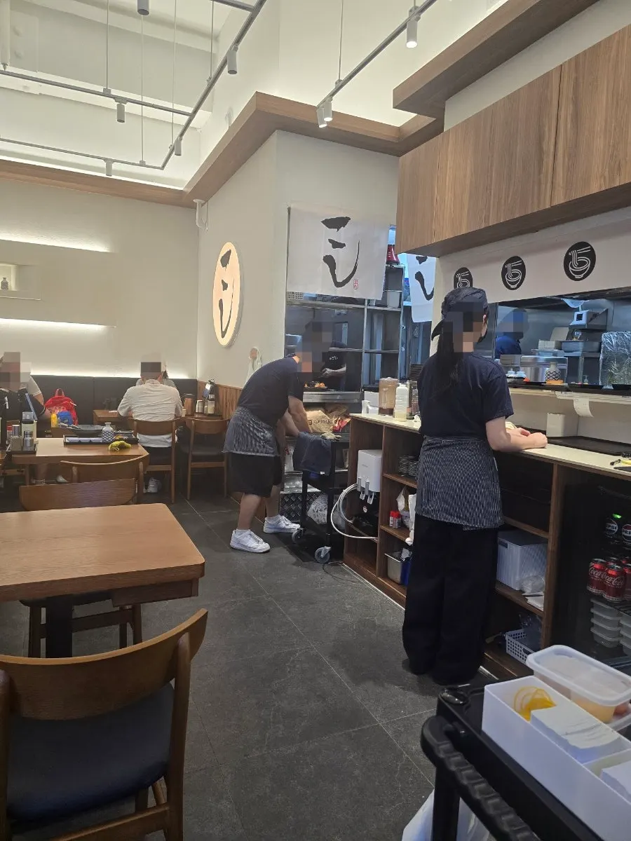 Interior seating with 4-person tables and a bar table