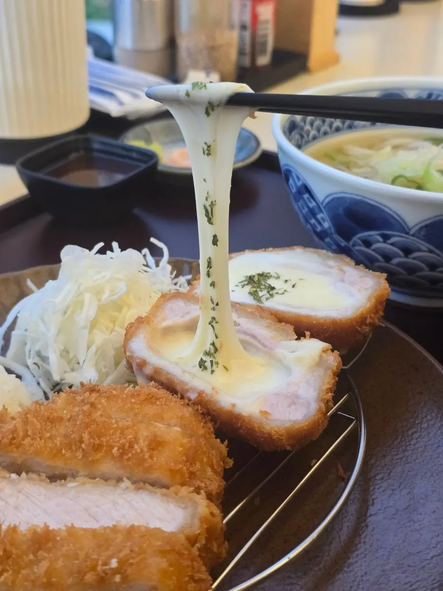 Cheese katsu with cheese stretching in long strings