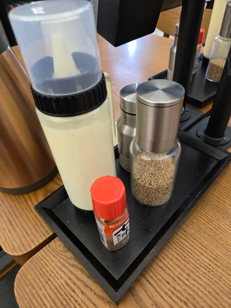 Table setup with kiosk, shichimi, and sesame seeds