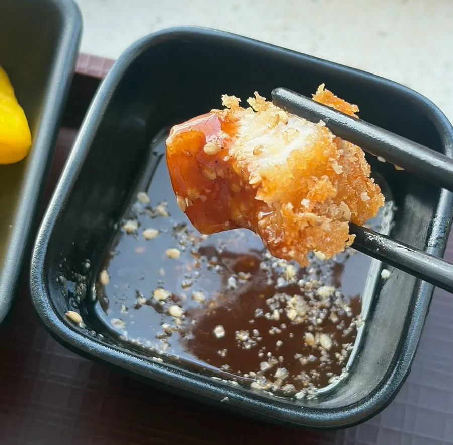 Tonkatsu dipped in sauce sprinkled with sesame powder